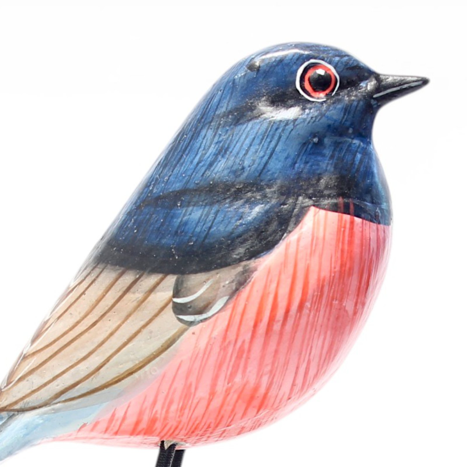Detailed close-up of hand-painted wooden robin bird figurine plumage