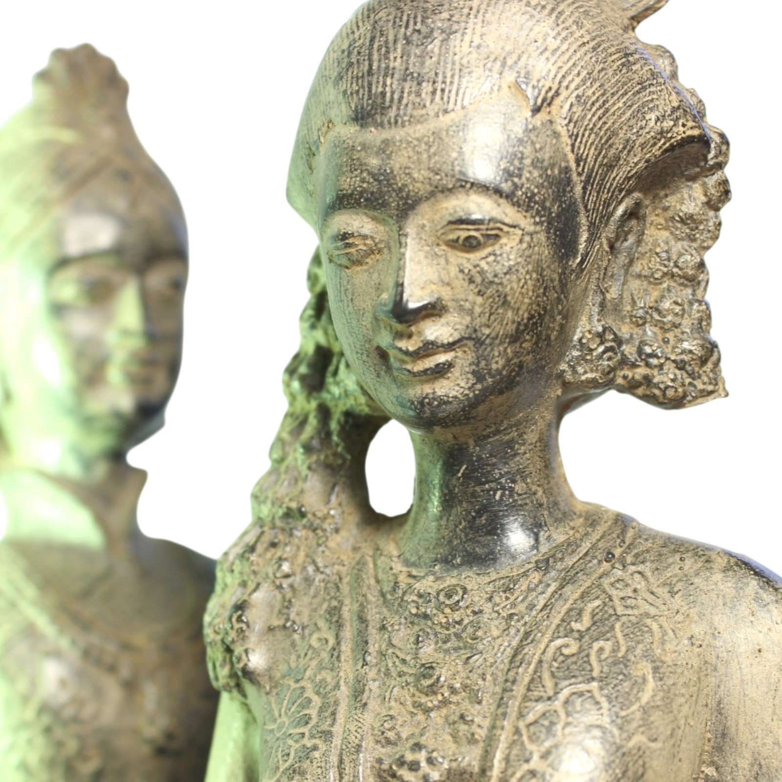 Close-up of the female figure's face, earring, and hair detail