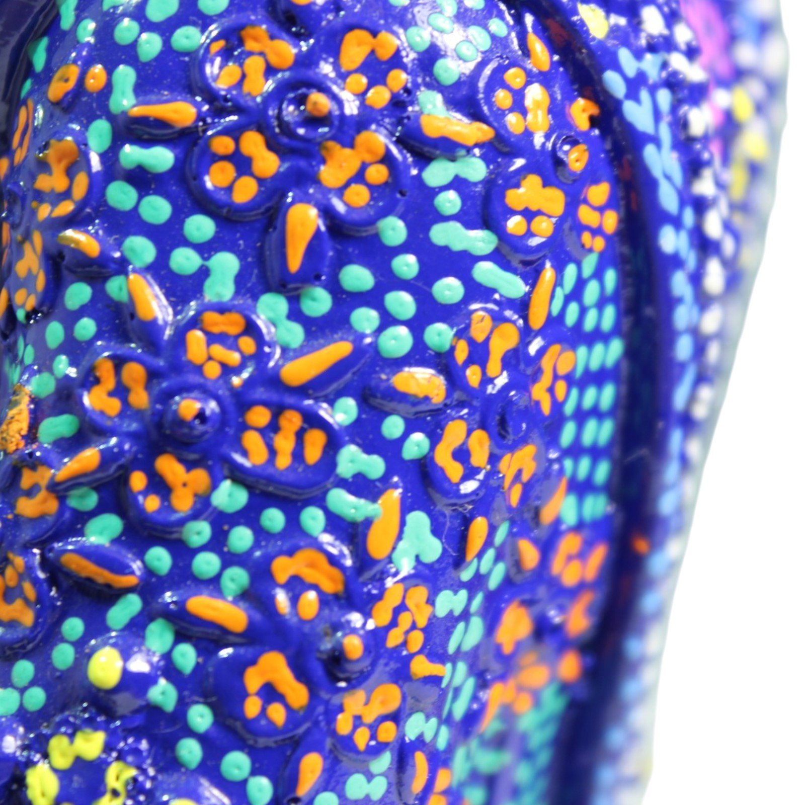 Close-up of embossed floral pattern on robe with orange and teal accents