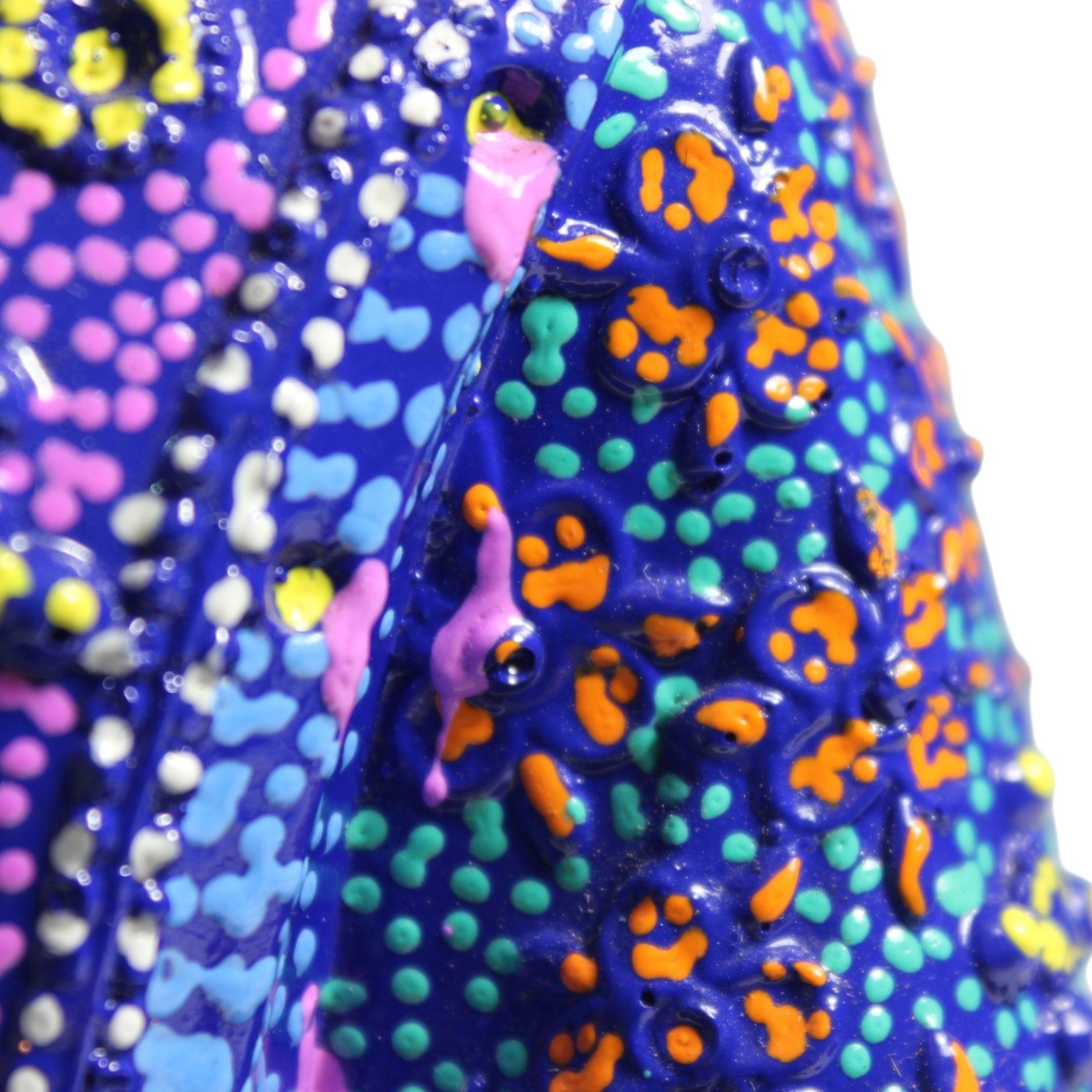 Macro shot of textured robe fabric with orange and teal dot painting