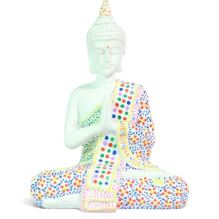 Front view of cream painted Buddha statue seated in prayer with colorful dotted robe