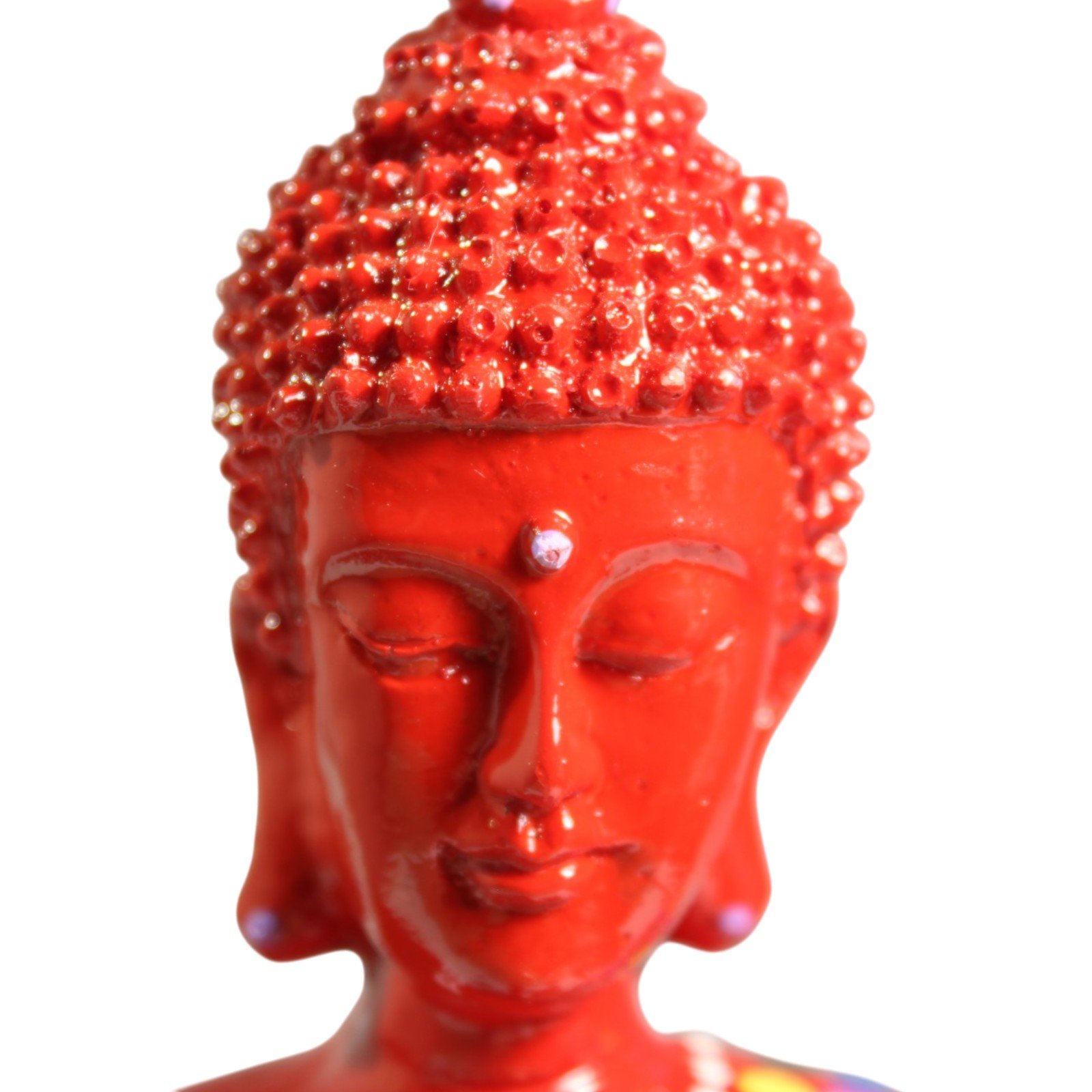 Close-up of the Buddha's serene painted face and topknot