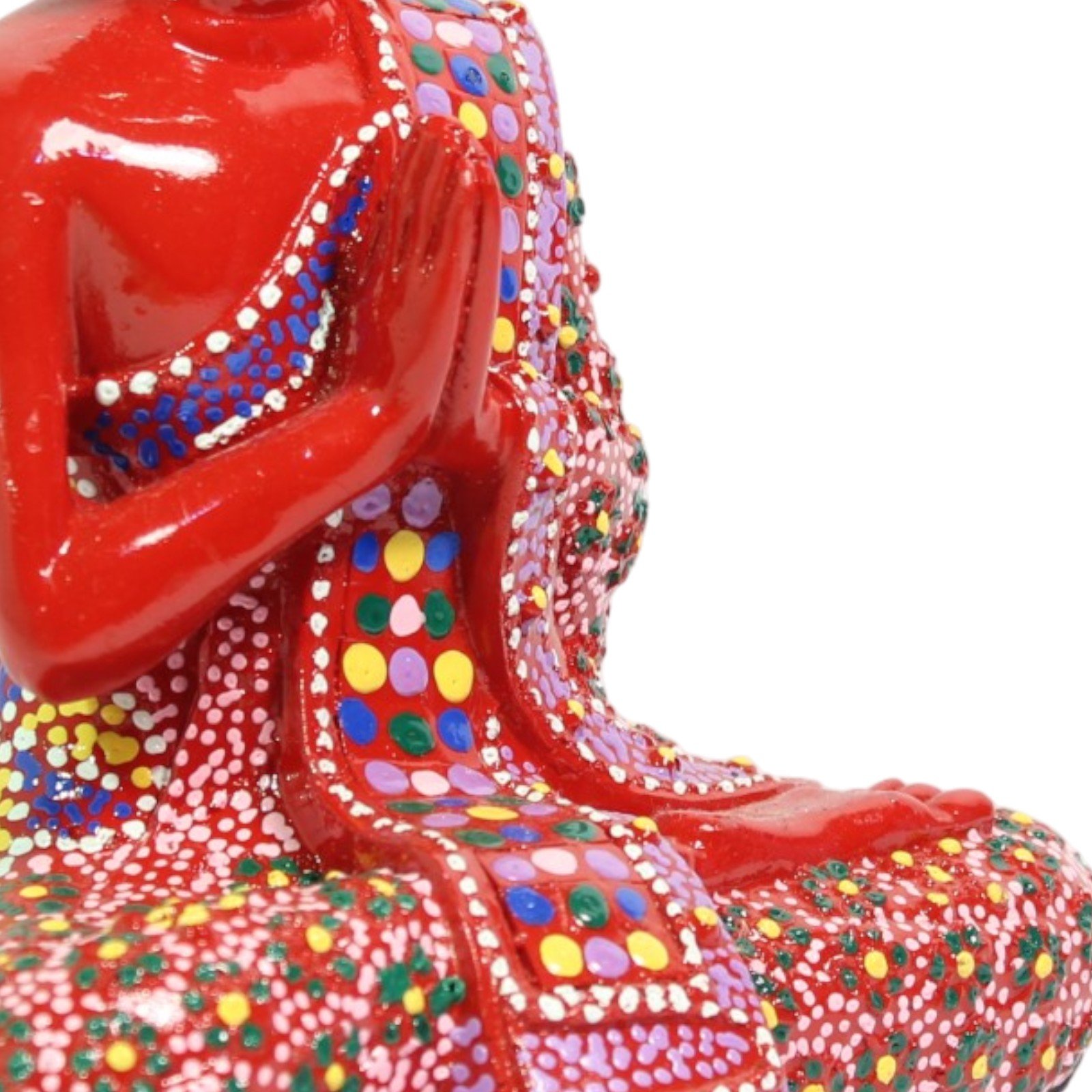 Close-up of praying hands and shoulder showing detailed dot-painted robe pattern