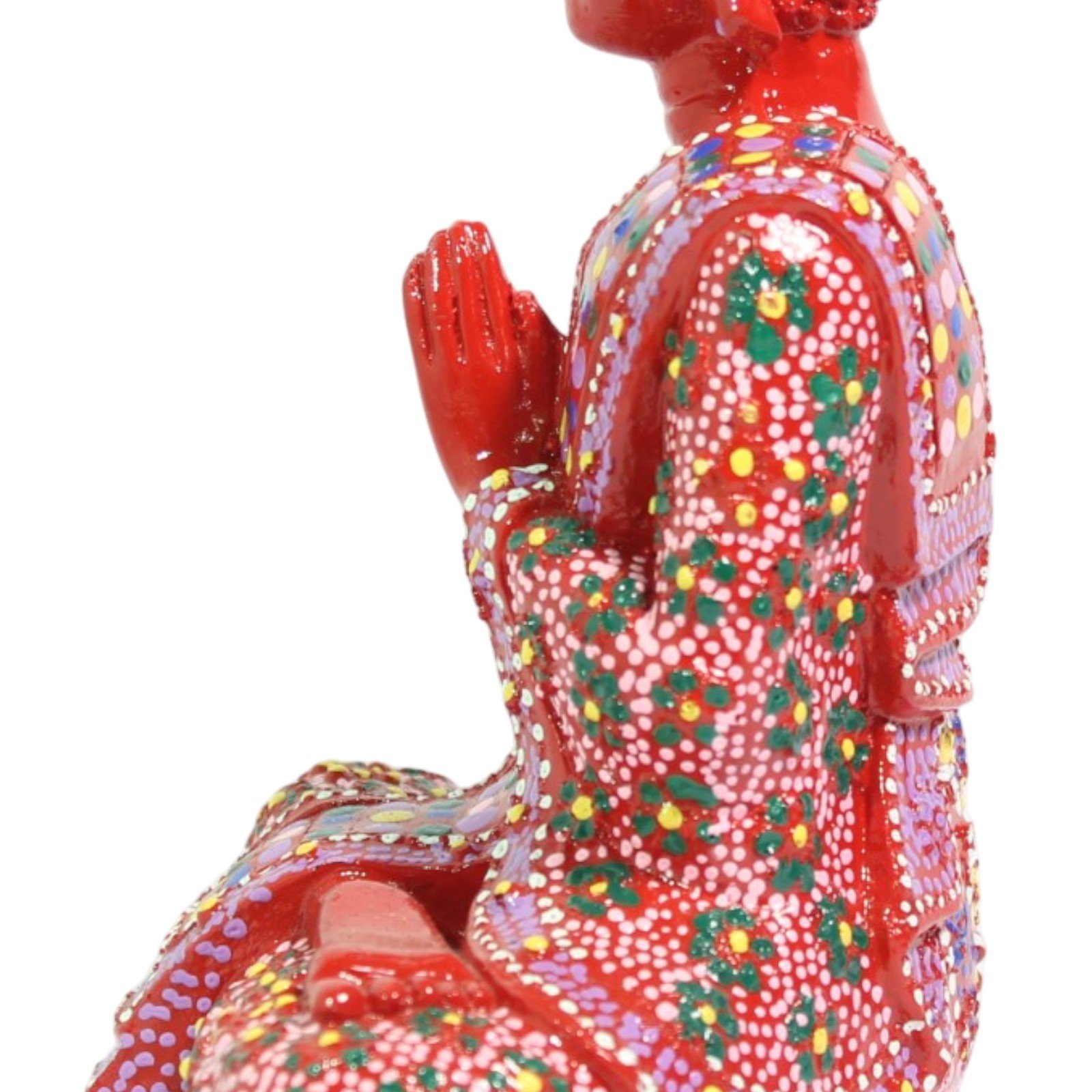 Close-up of praying hands from the side with dotted robe pattern behind