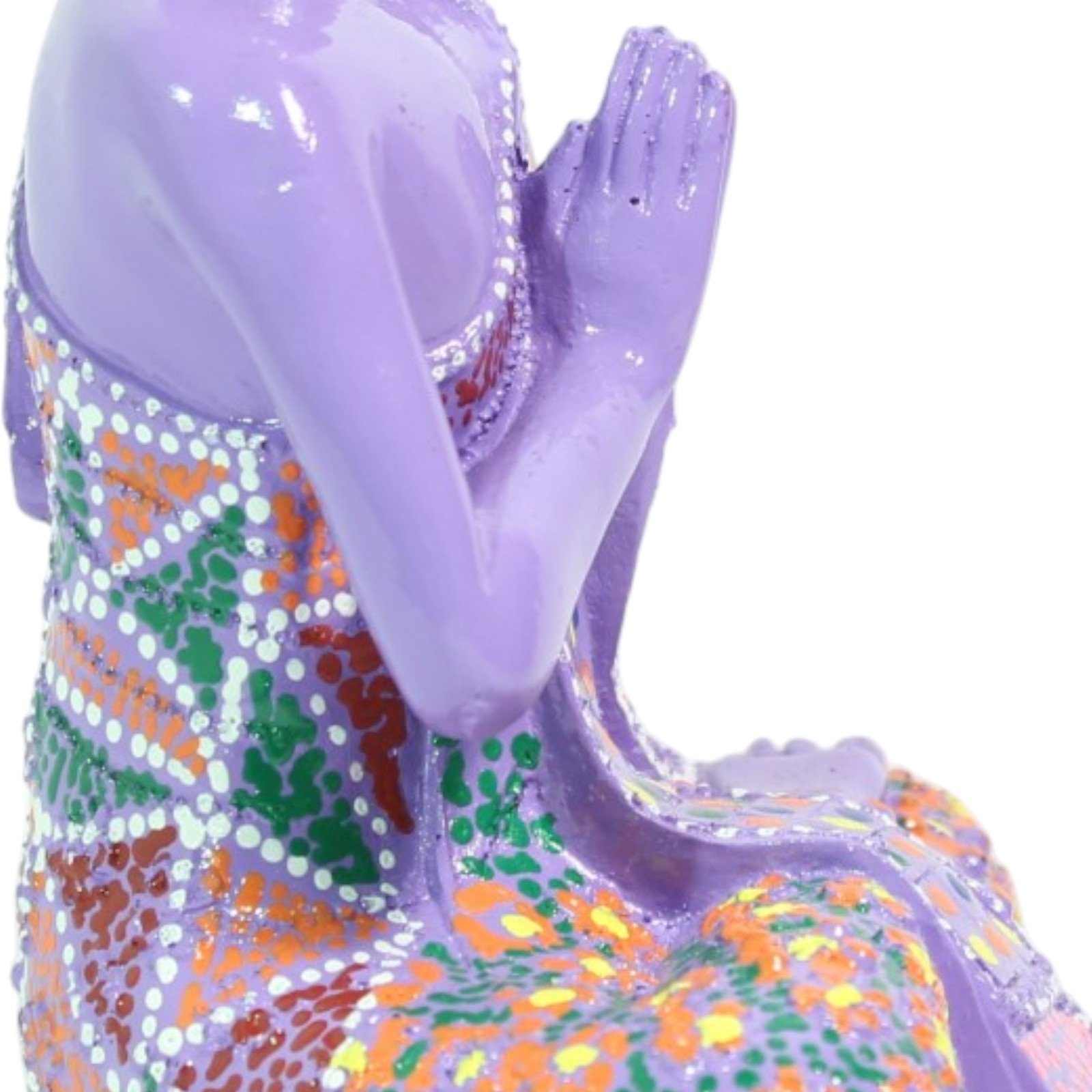 Close-up of the folded hands in prayer position against the patterned robe