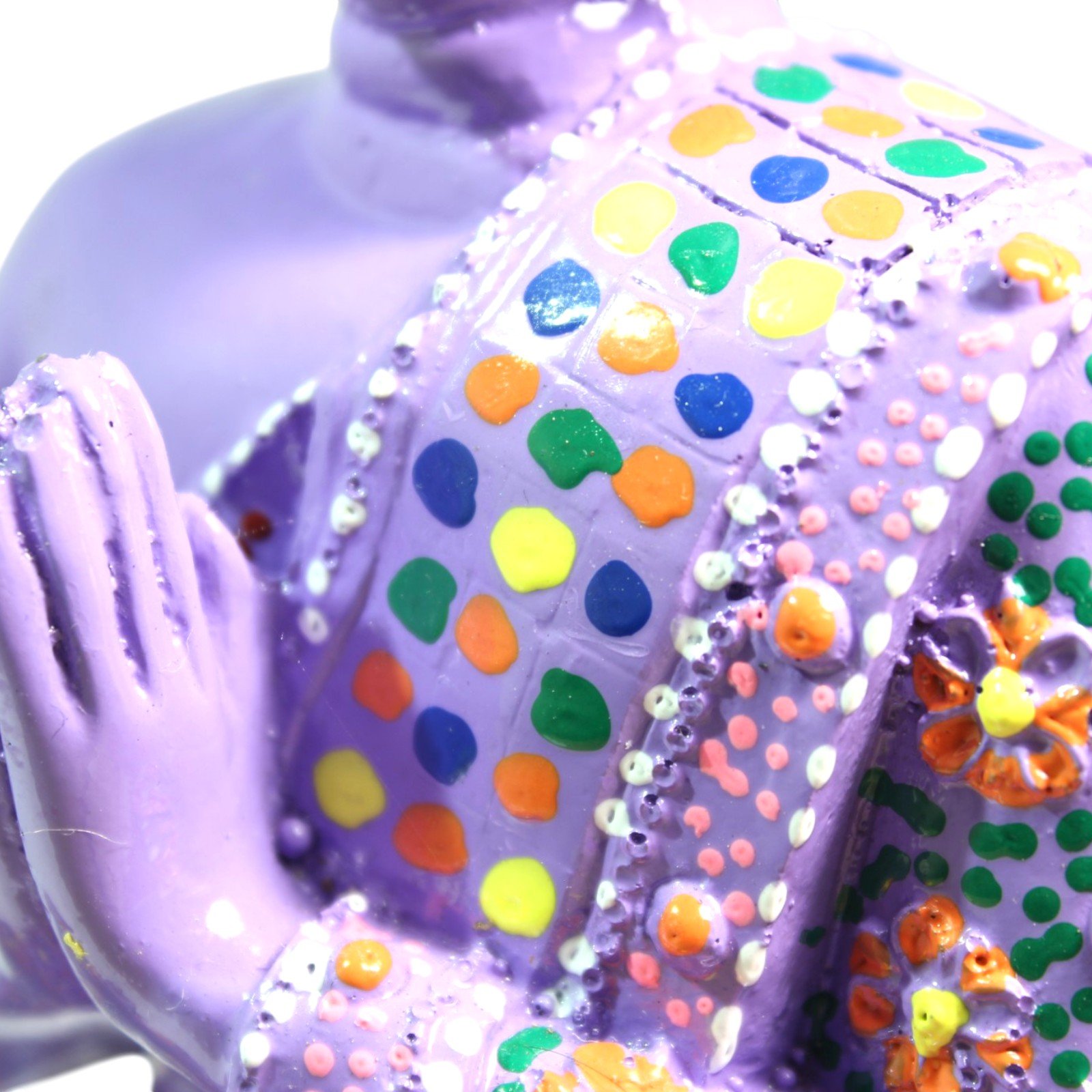 Close-up of the geometric dot pattern on the robe in blue, green, orange, and yellow