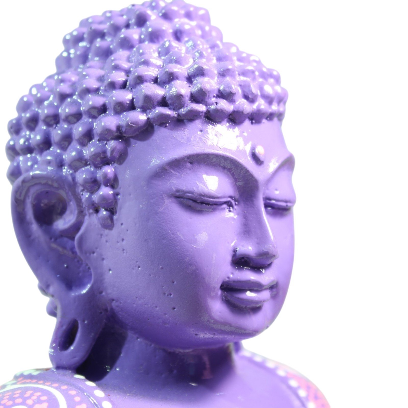 Close-up of the Buddha's serene painted face with closed eyes and purple finish
