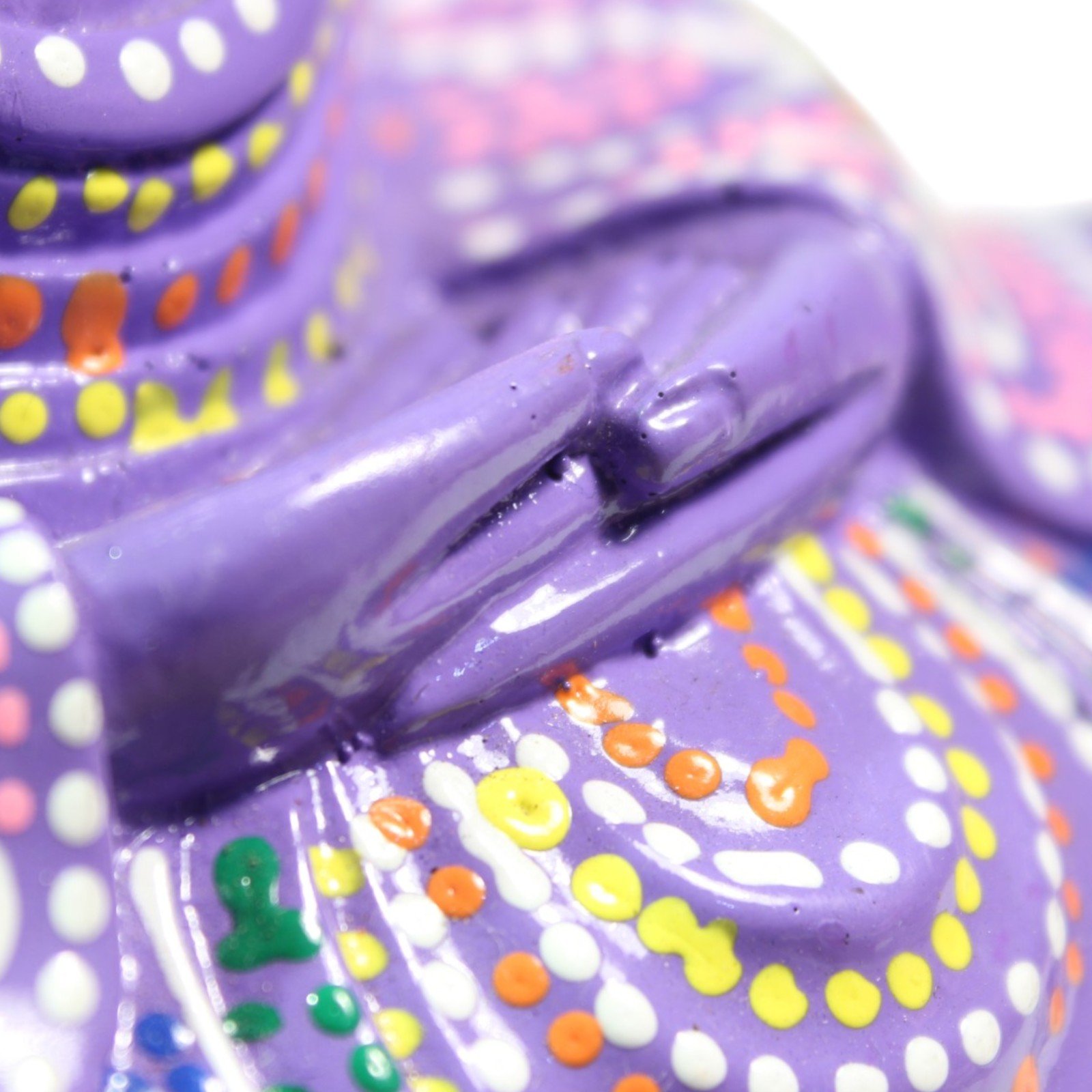 Close-up of the Buddha's hands resting in the meditation mudra pose