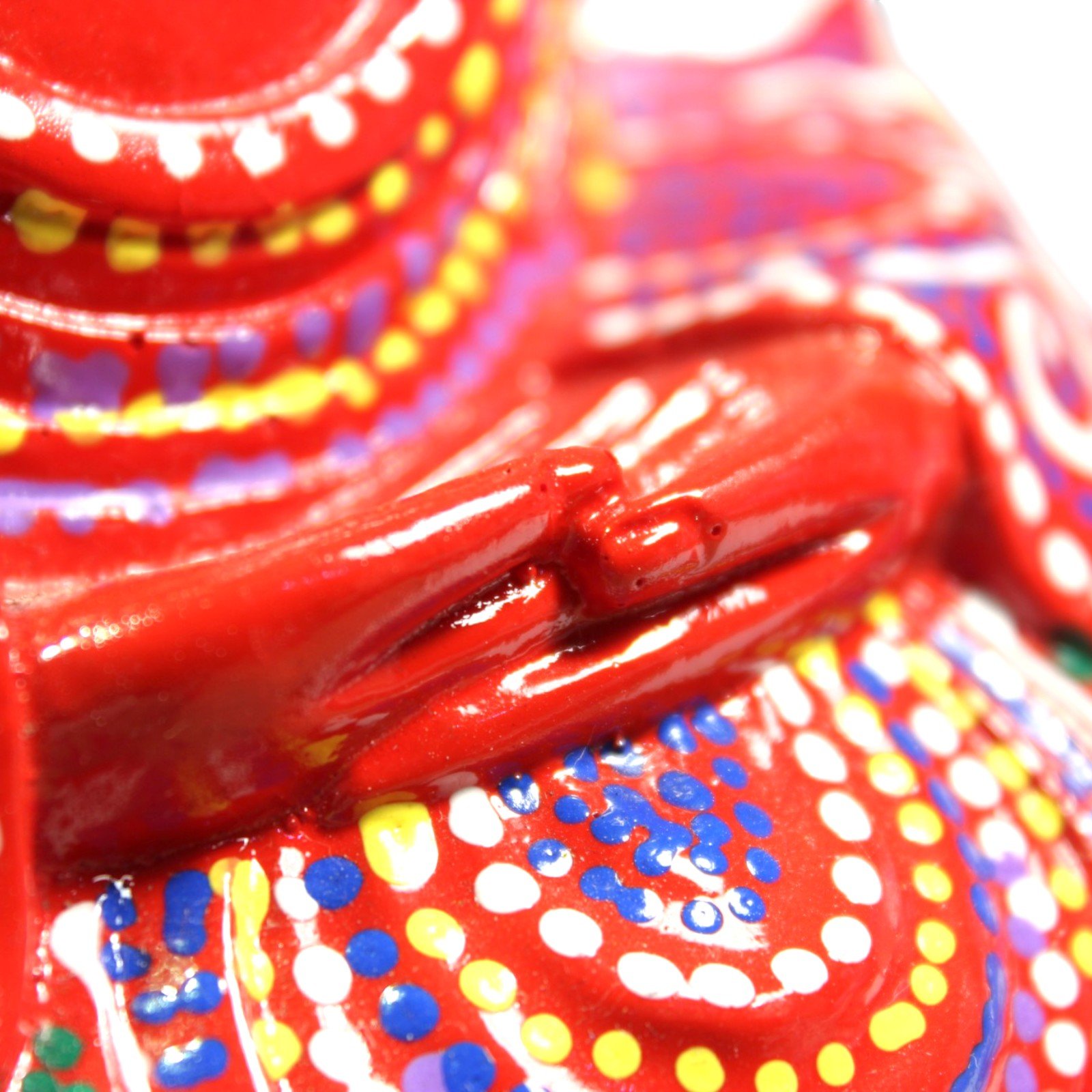 Macro shot of the Buddha's hands resting in meditation mudra, showing sculpted detail