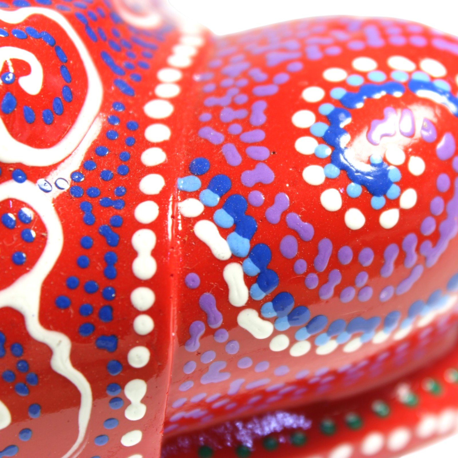 Extreme close-up of paint texture showing raised dots and glossy finish on the robe