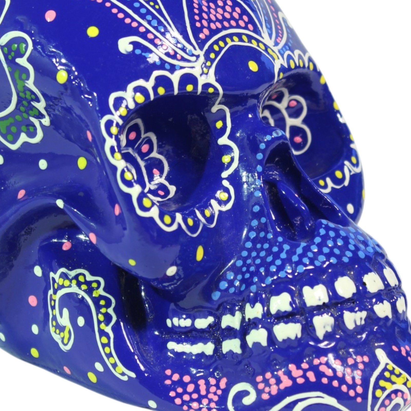 Close-up of the skull's eye sockets and painted teeth with dotted floral detailing