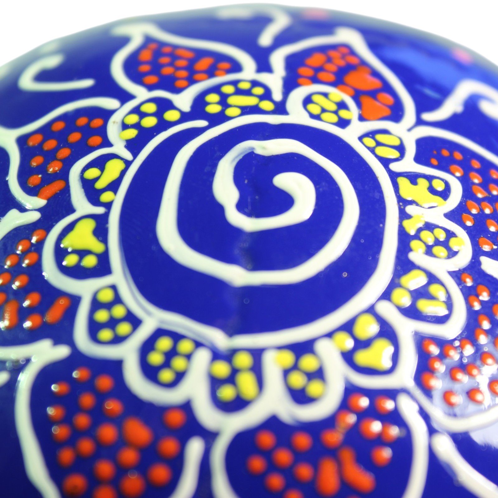Close-up of paisley wing pattern with pink dotted shading on blue background