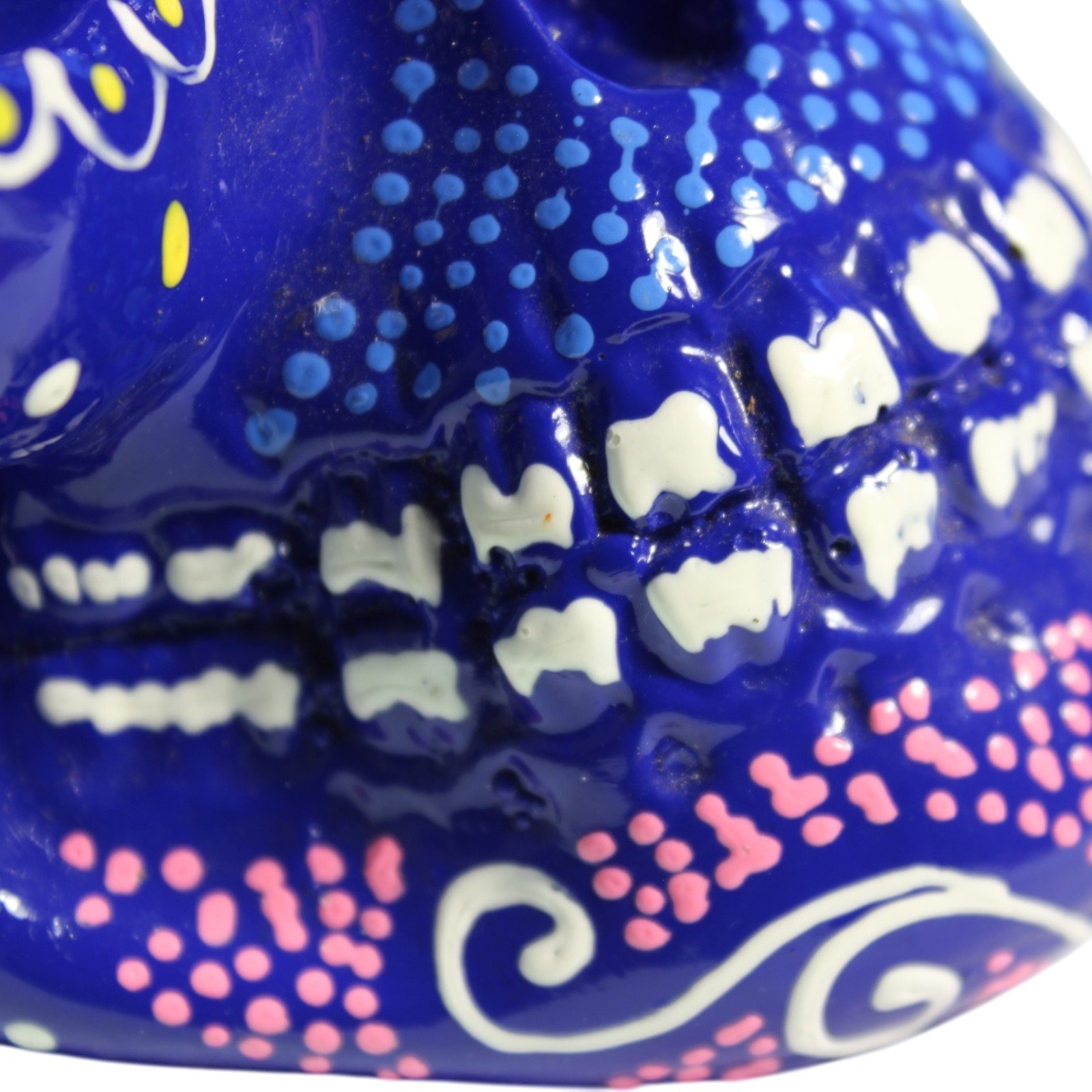 Macro detail of the painted teeth and jaw with blue dotwork accents