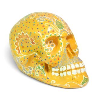 Side profile view of the orange painted skull highlighting swirl and dot patterns