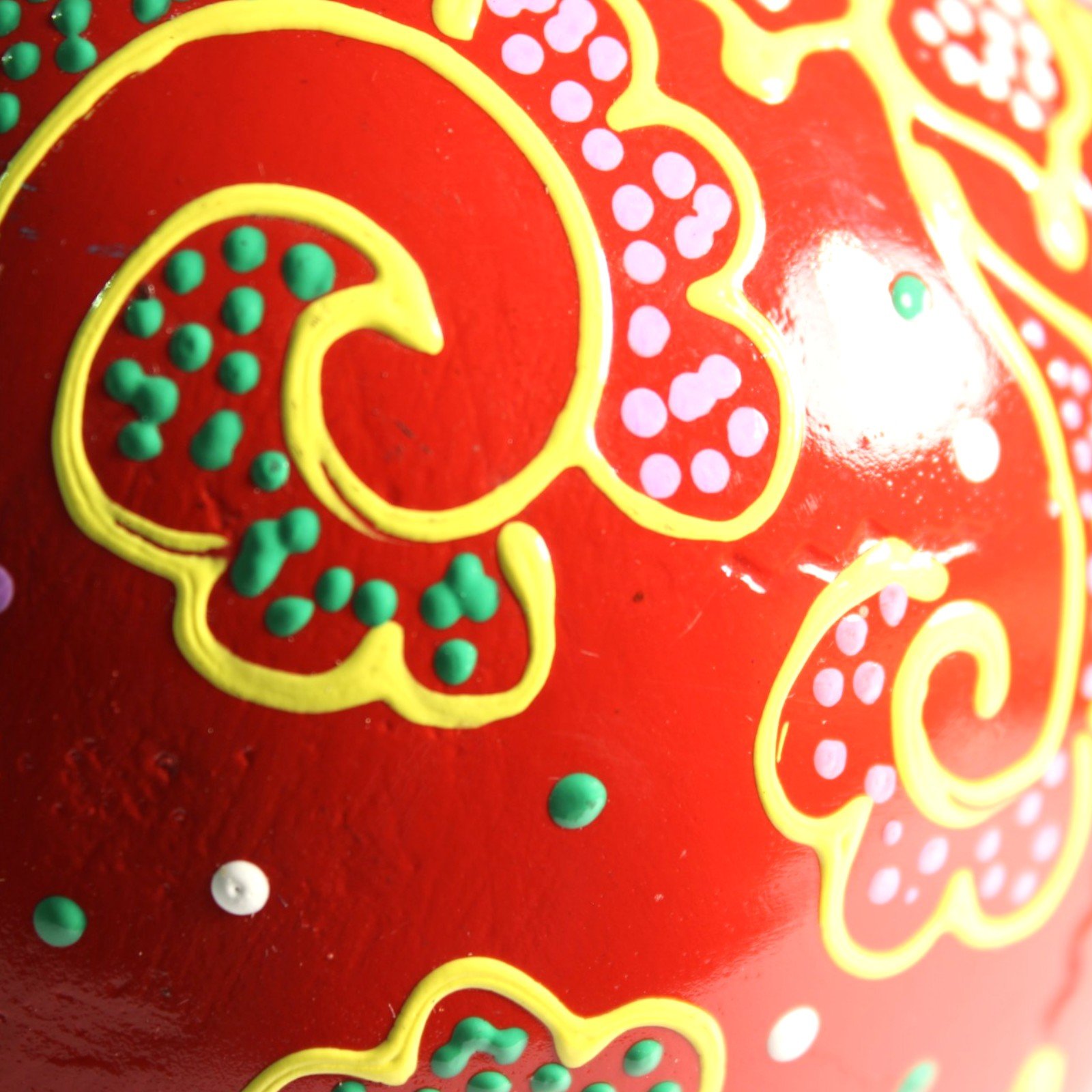 Close-up side pattern detail with green and pink dotted swirls