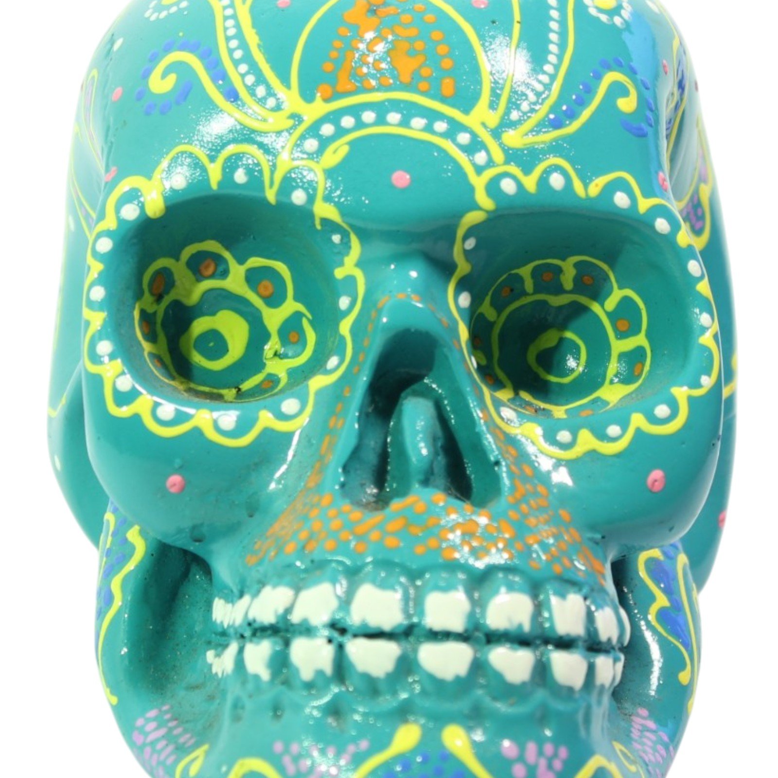 Close-up front view of teal resin skull showing hand-painted eye and nose detail