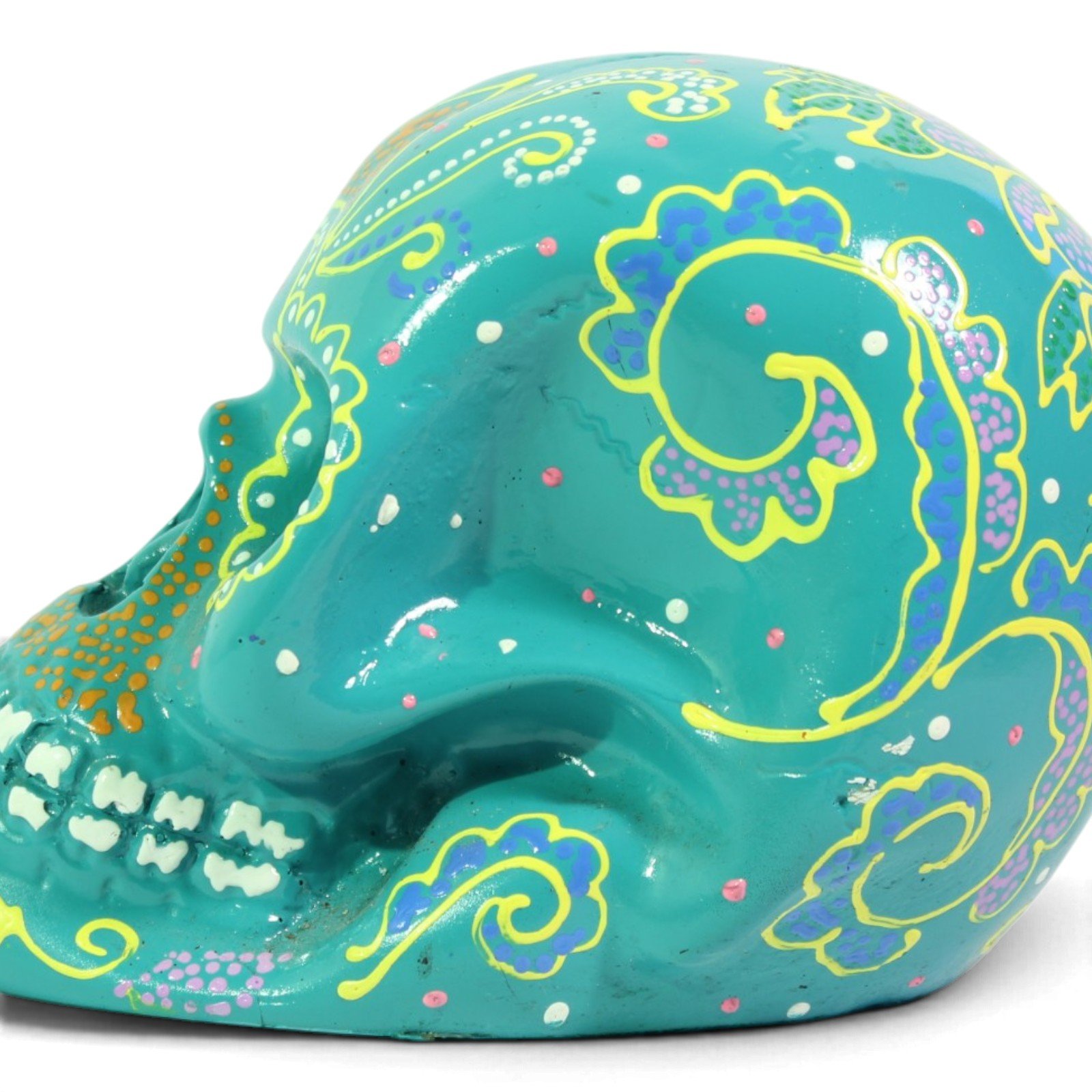 Side close-up of the skull showing painted swirl and floral patterns on the cheek