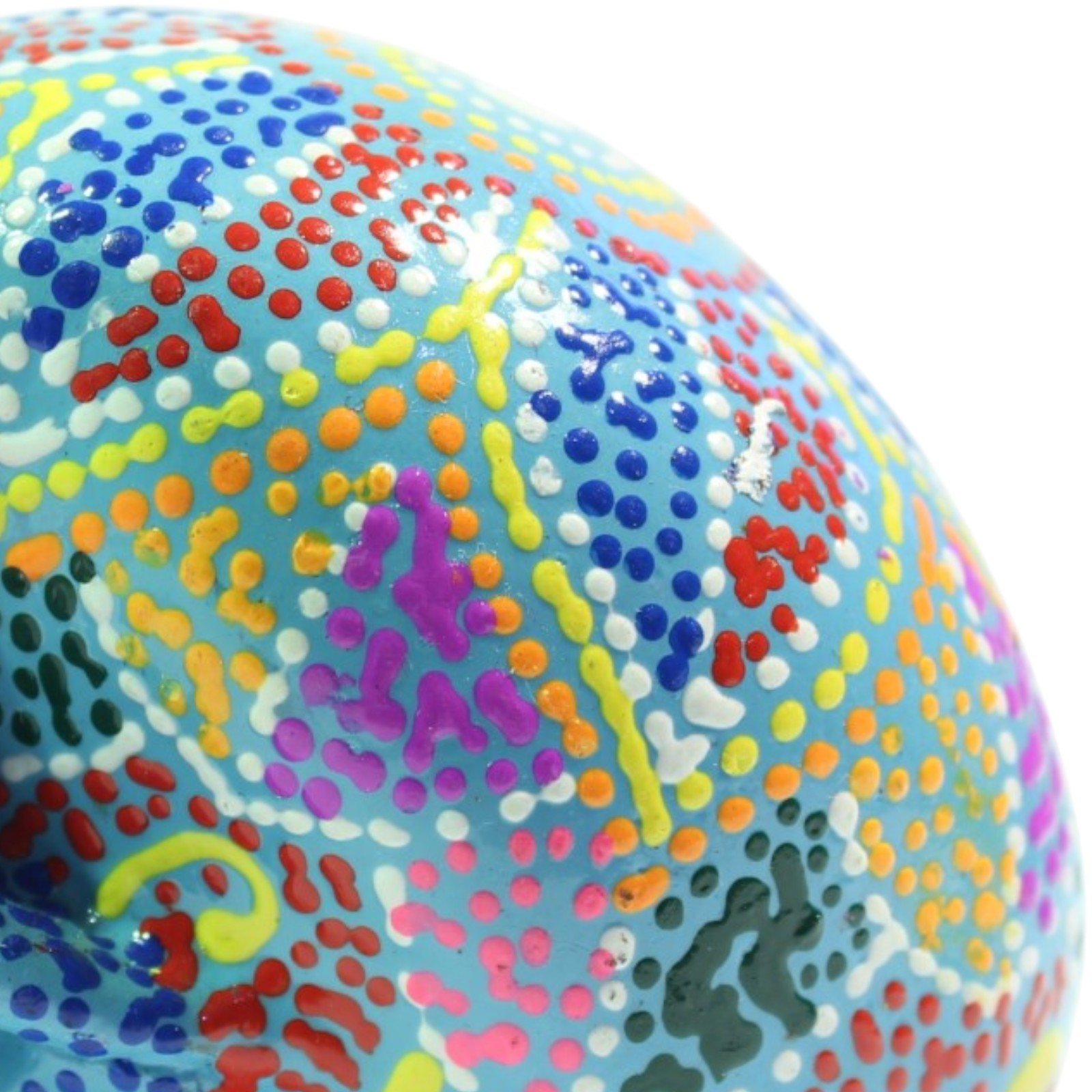 Extreme close-up of the painted surface texture showing layered dots in purple, red, yellow, and blue