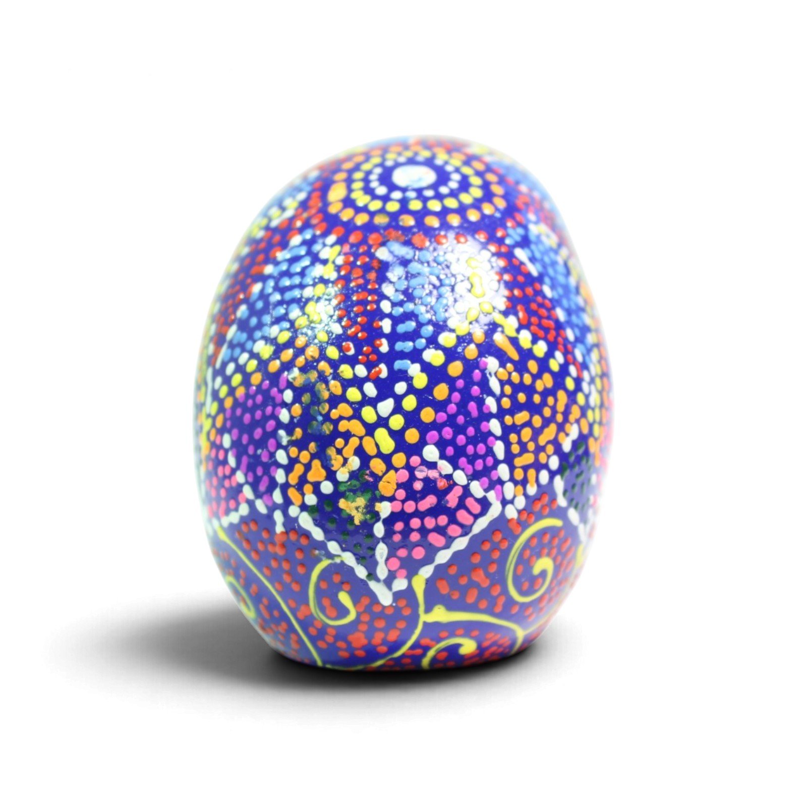 Back view of the skull showing dense dot-mandala pattern in blue, red, and yellow