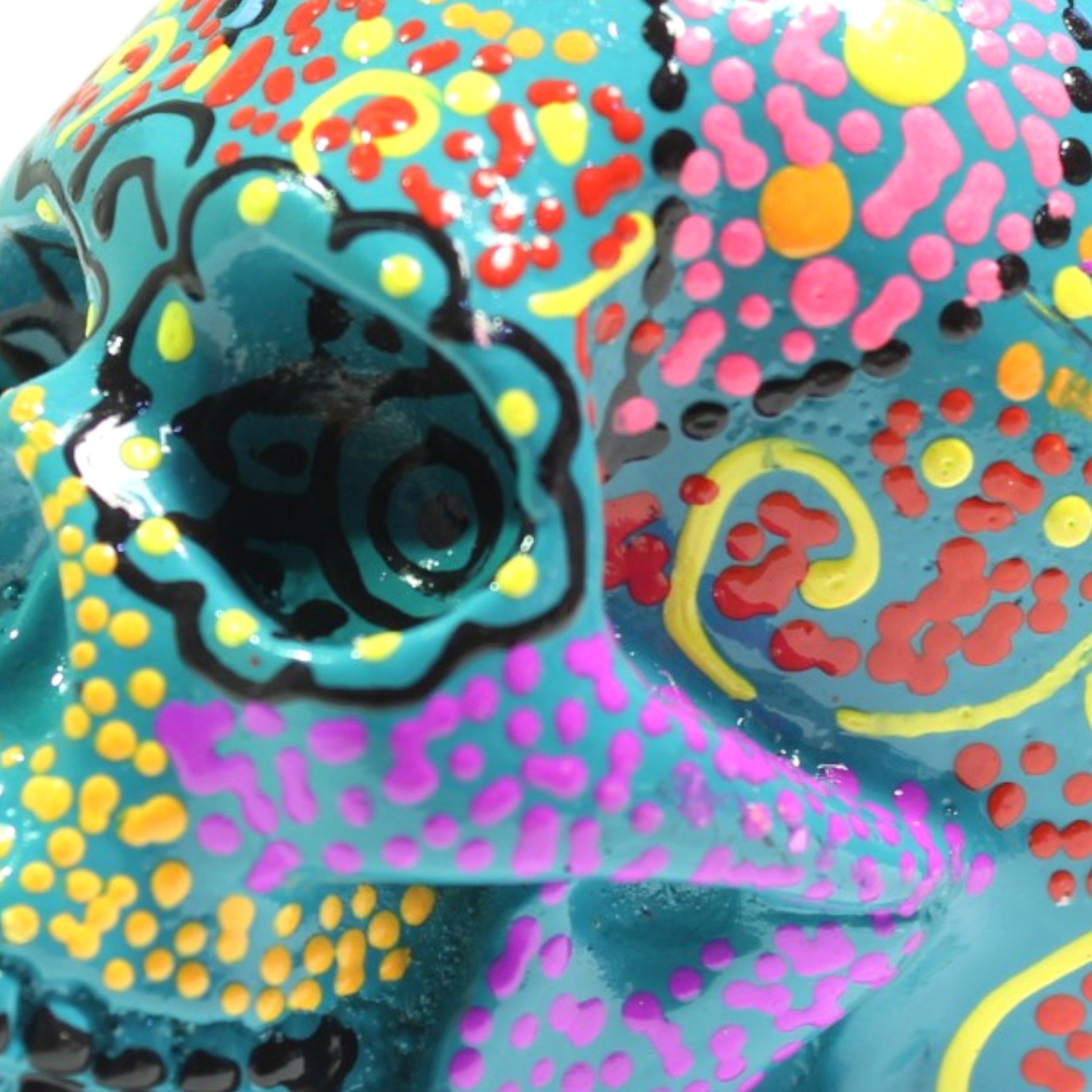 Close-up of eye socket and dotted paint detail on green skull