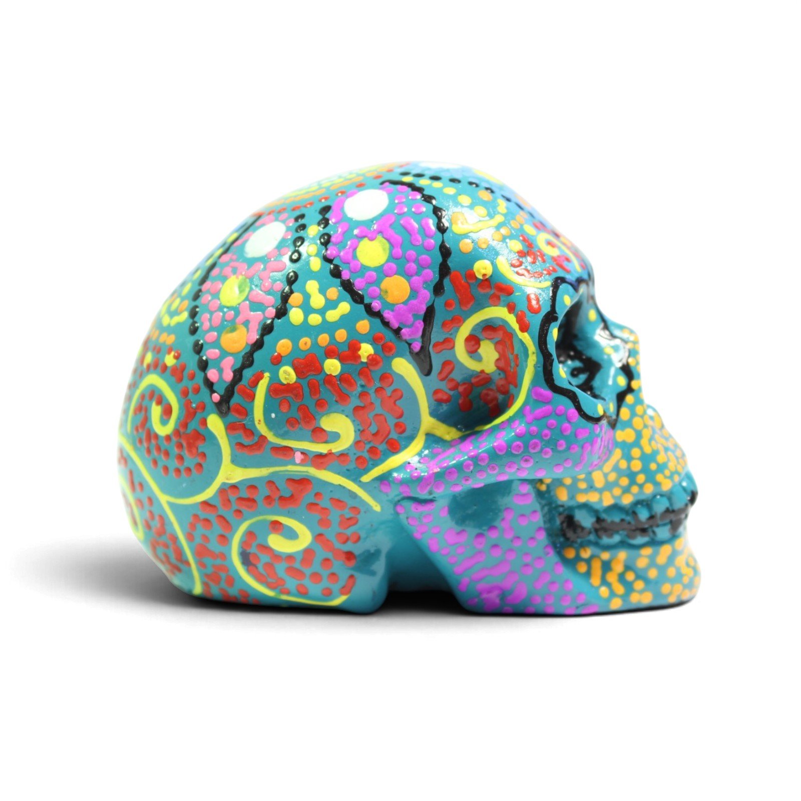 Painted green skull figurine viewed from opposite side profile