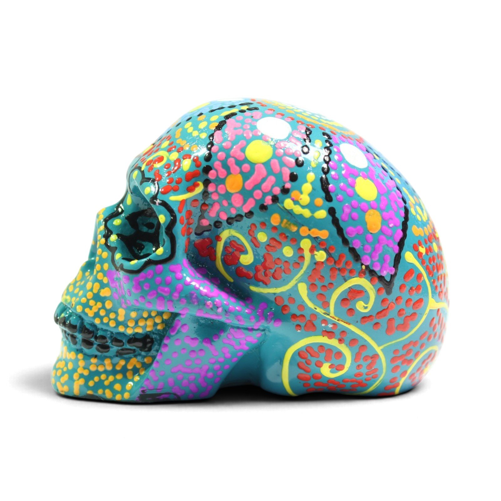 Left side profile of the painted green skull figurine