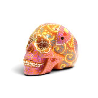 Orange resin skull figurine with colorful dot-painted mandala patterns, side view