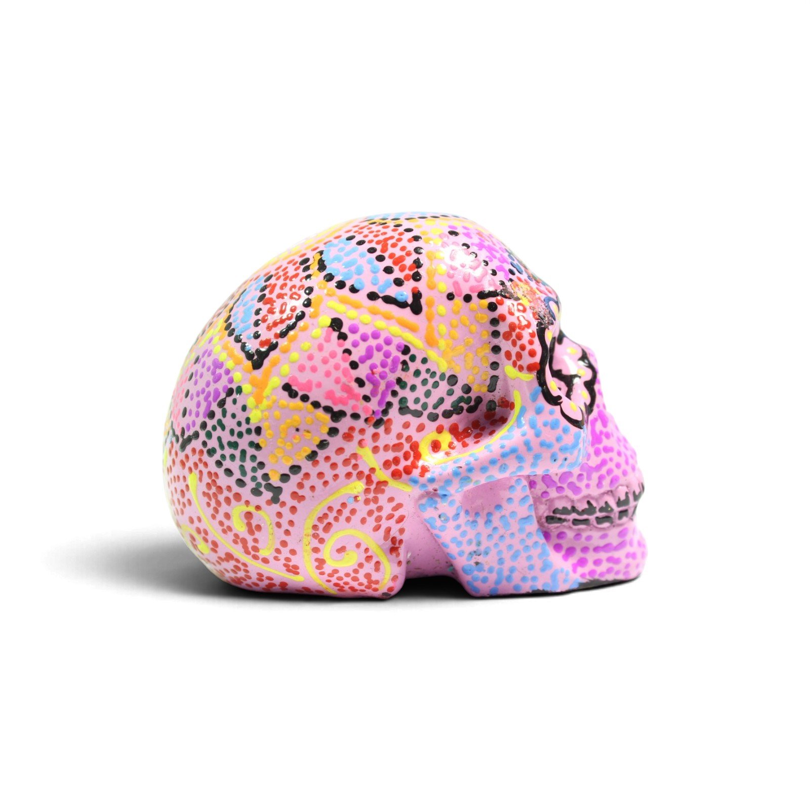 Side view of the pink skull figurine showing dotted design and profile shape