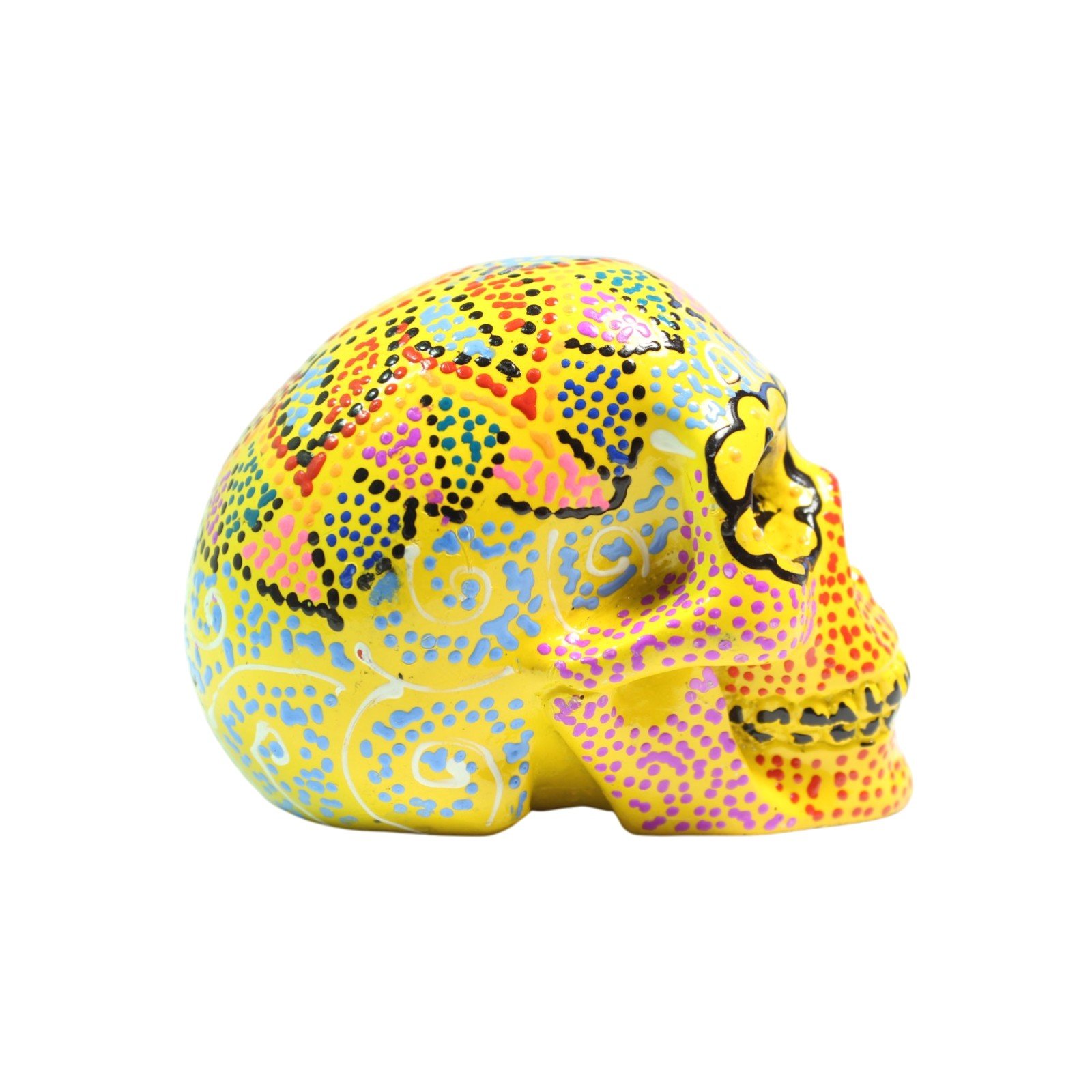 Side profile view of the yellow painted skull figurine showing full design