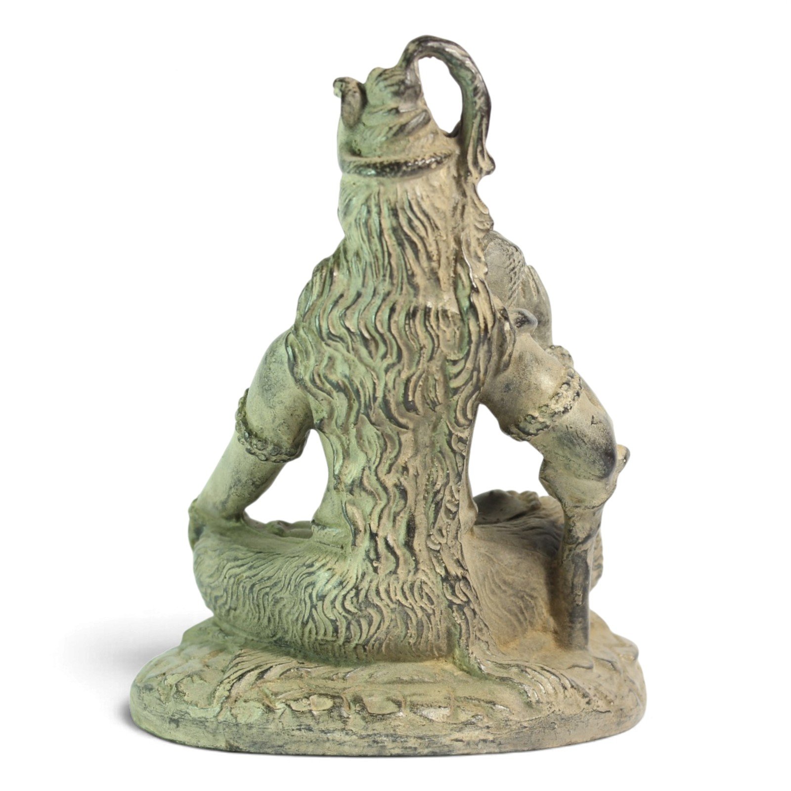Back view of Shiva statue showing flowing carved hair and crossed legs