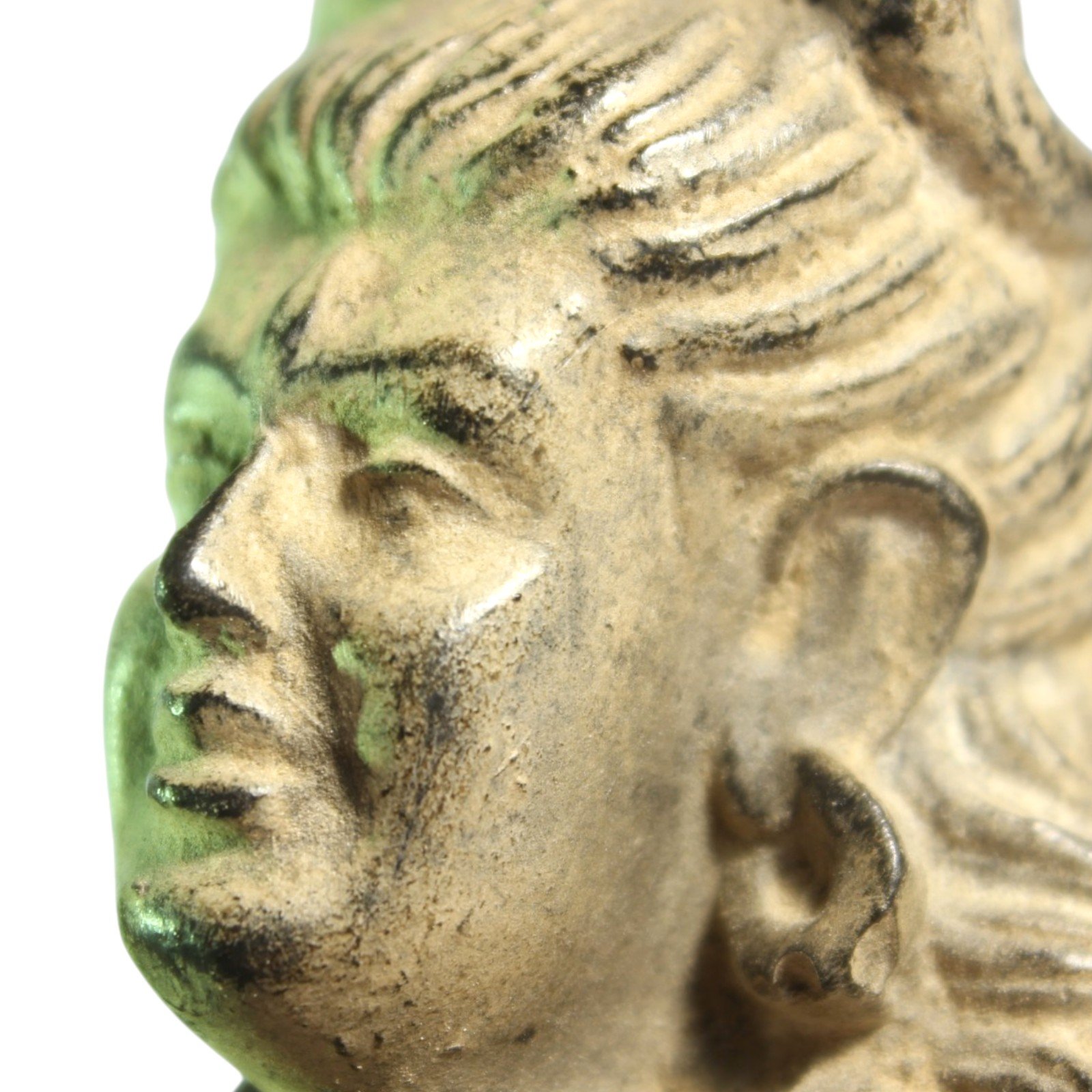 Close-up profile of Shiva statue's face and carved hair texture