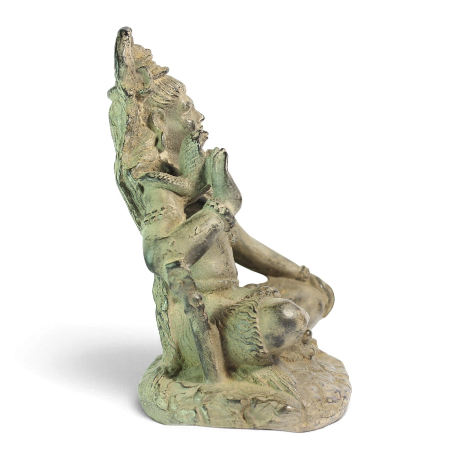 Side view of Shiva statue in full seated meditation pose against white background