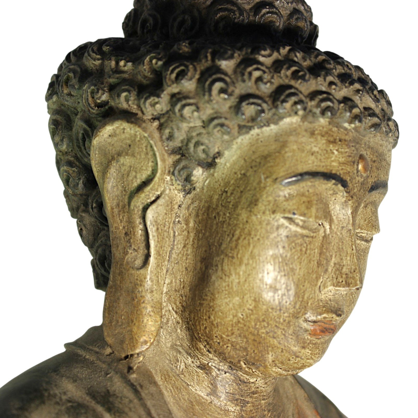 Close-up of the Buddha's face and ear showing hand-applied paint texture