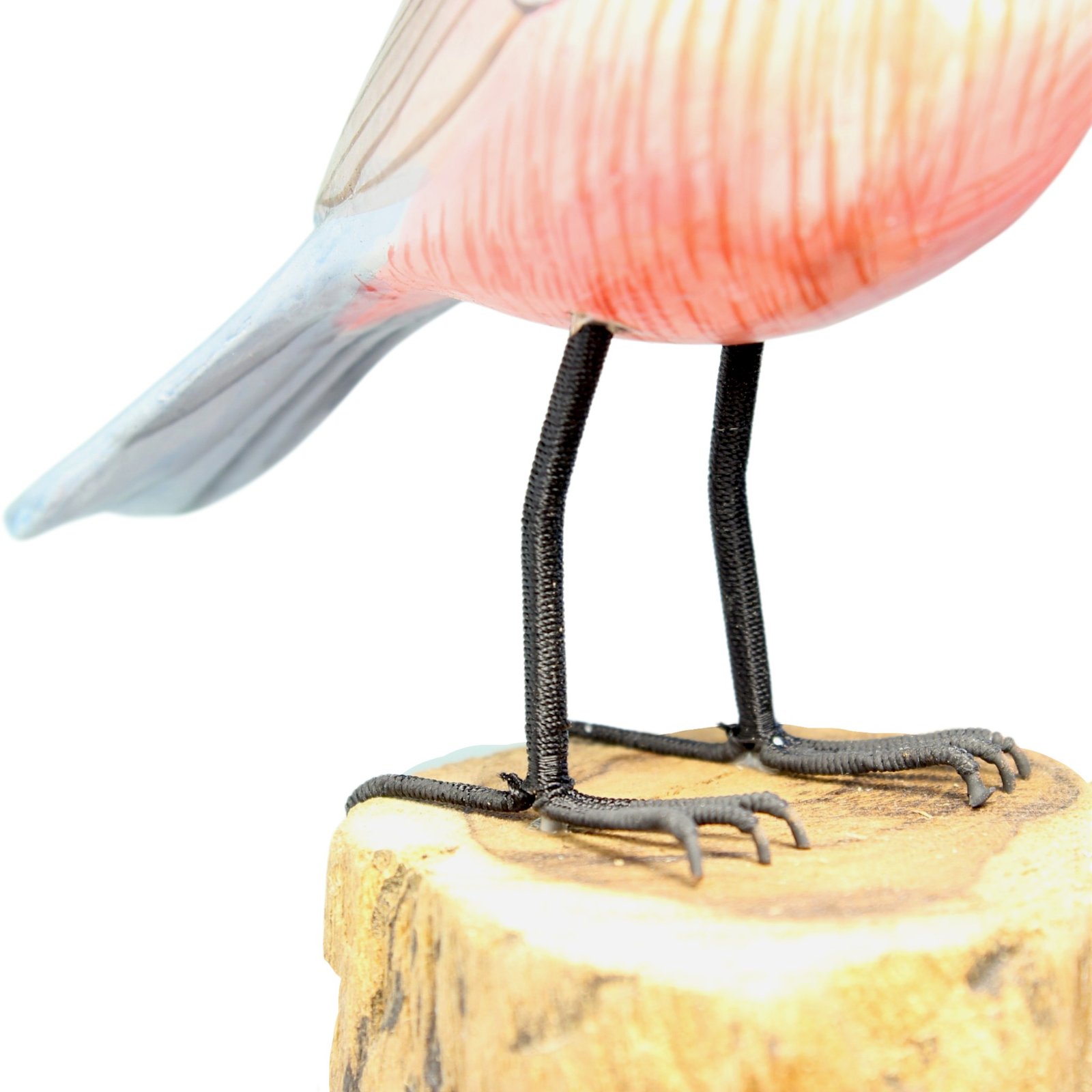 Detail of wire legs and feet on hand-carved wooden bird figurine