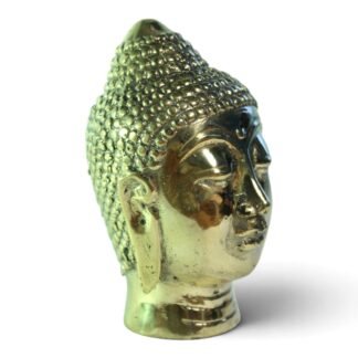 Side profile of hand-cast brass Buddha head showing curled hair and elongated earlobe