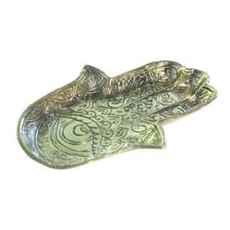 Angled view of engraved brass hamsa hand dish showing intricate scrollwork detail