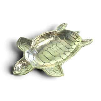 Brass sea turtle trinket dish shown at an angle, highlighting the carved shell texture