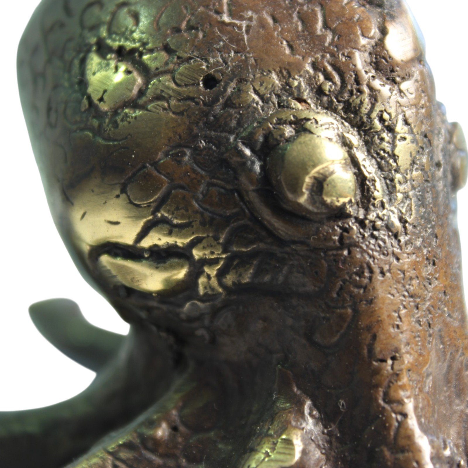 Brass octopus figurine seen from an elevated angle showing detailed head
