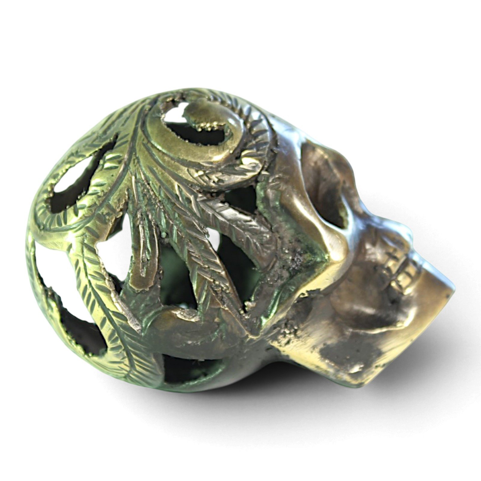 Handvara view of the brass skull figurine showing symmetrical carving and aged finish