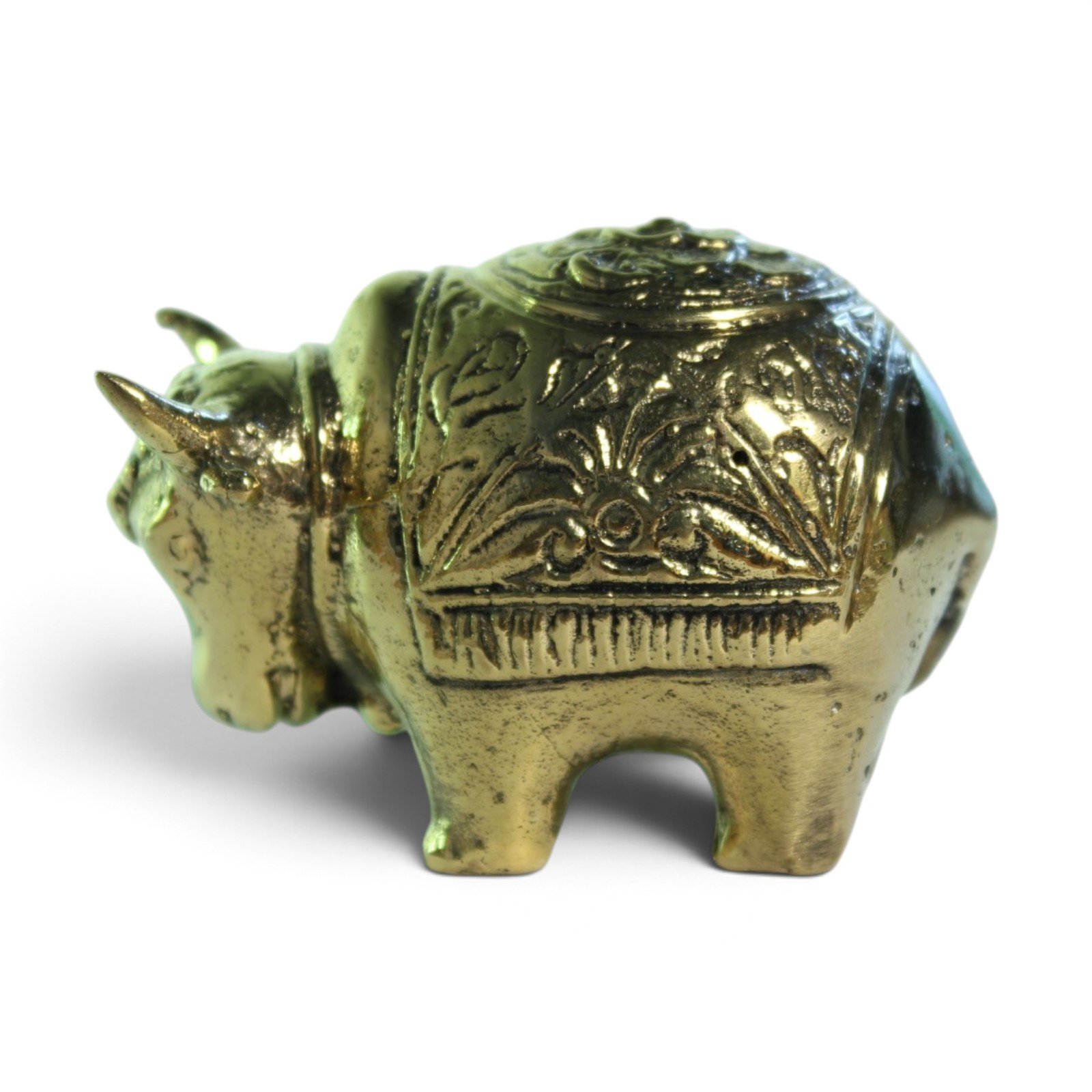 Rear three-quarter view of brass bull figurine highlighting carved patina and back legs