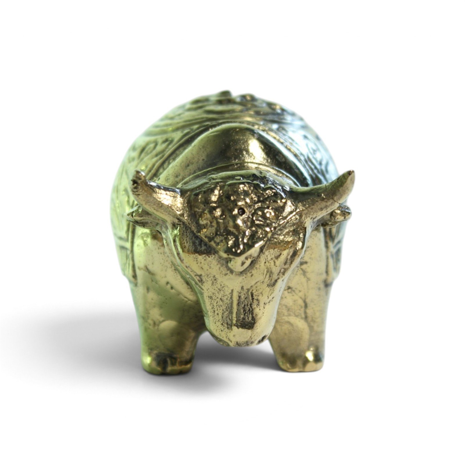 Front view of brass bull figurine showing horns and face detail