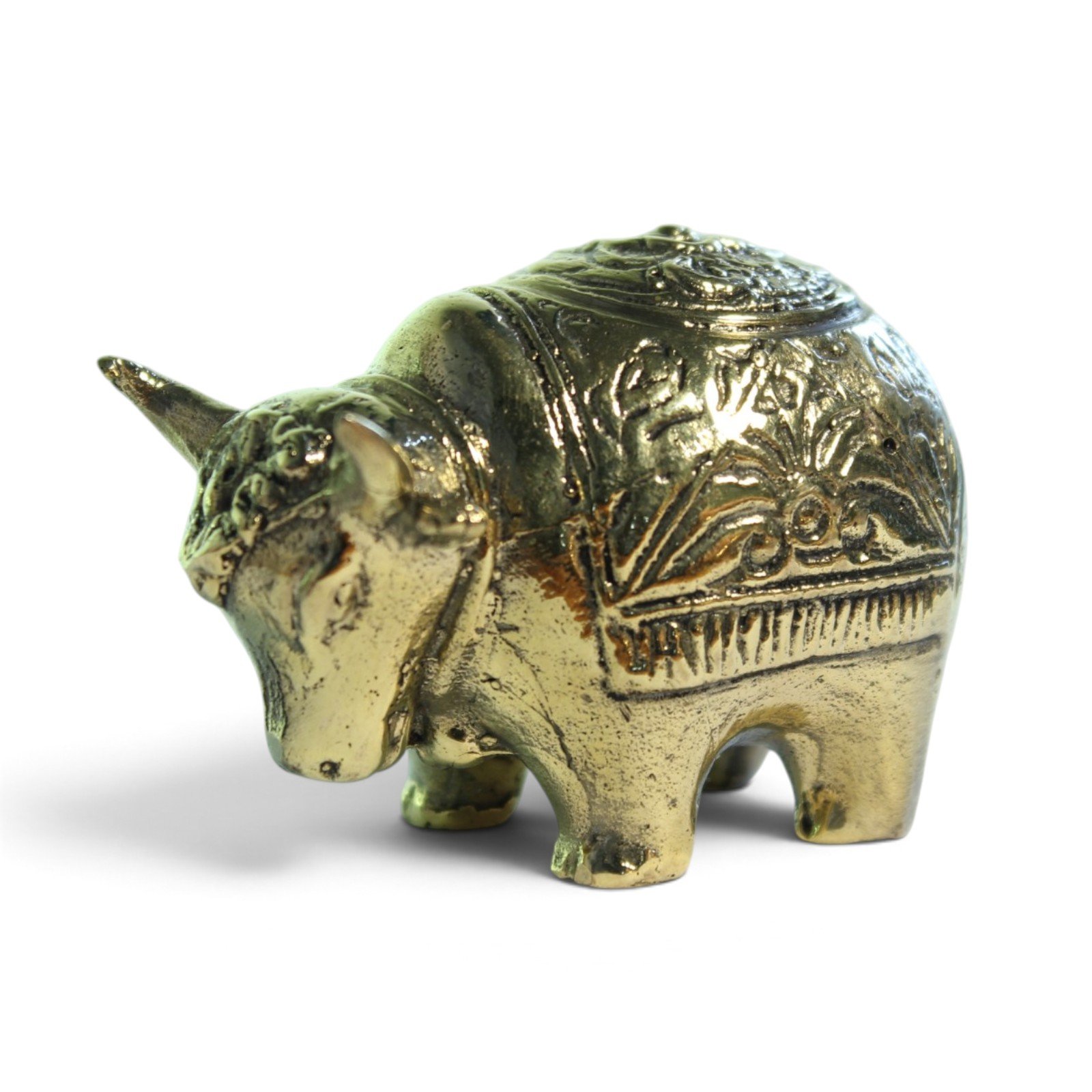 Brass bull figurine viewed from the opposite side showing carved floral back panel