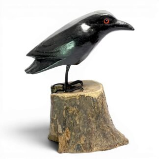 Hand-carved wooden crow figurine with glossy black finish, side profile on a natural wood base
