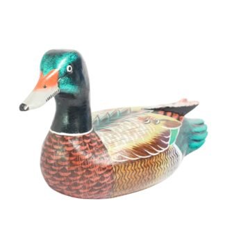 Hand-painted wooden duck figurine, three-quarter angle showing head and painted wing detail