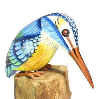 Hand-carved wooden kingfisher figure perched on a wood stump, head bowed in a diving pose