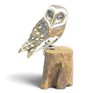 Hand-carved wooden barn owl figurine perched on a natural wood stump, front view