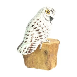 Hand-carved white owl figurine on a natural wood base, side angle view